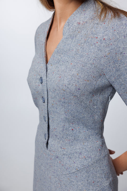 Close-up of the Dusty Blue bodice and 3/4 sleeves, showcasing the precision tailoring and smooth wool-blend finish.