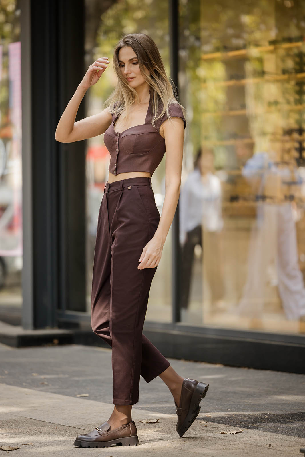 Detail of the sweetheart neckline and cap sleeves on a designer wool-blend structured top.