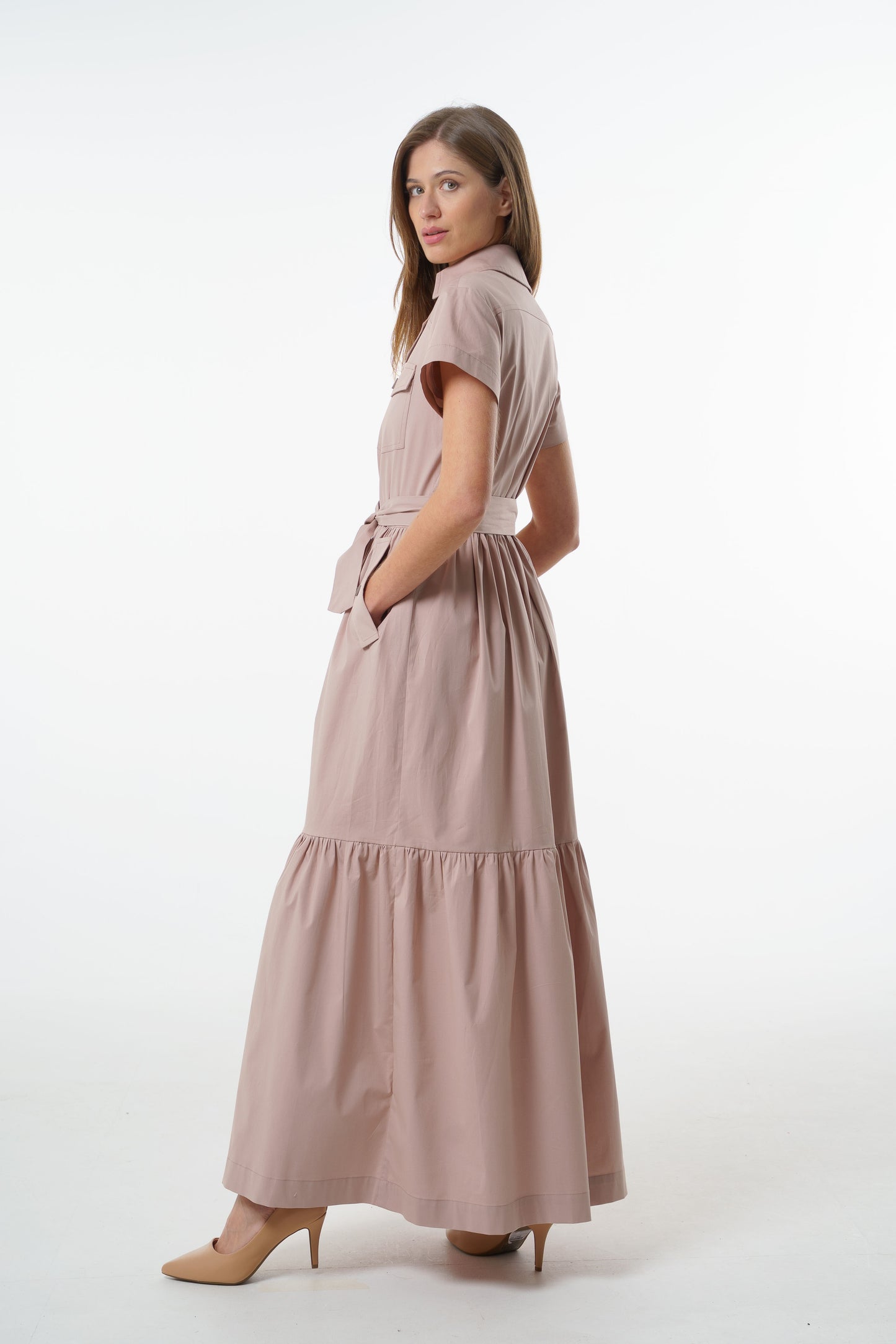 Dusty mauve cotton button‑down maxi shirt-dress with belted waist, short sleeves, and tiered skirt, angled front studio view on model.