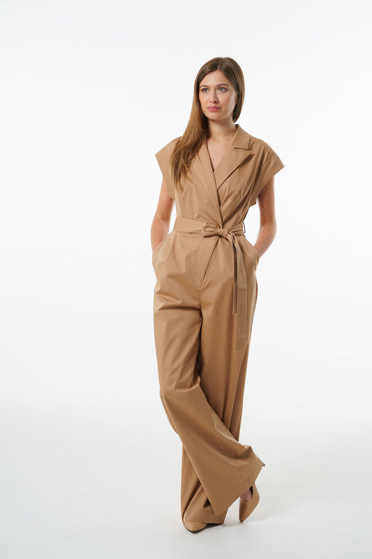 Camel cotton–viscose wrap‑front jumpsuit with wide‑leg silhouette, notched collar, and tied waist, worn by a model, front studio view.