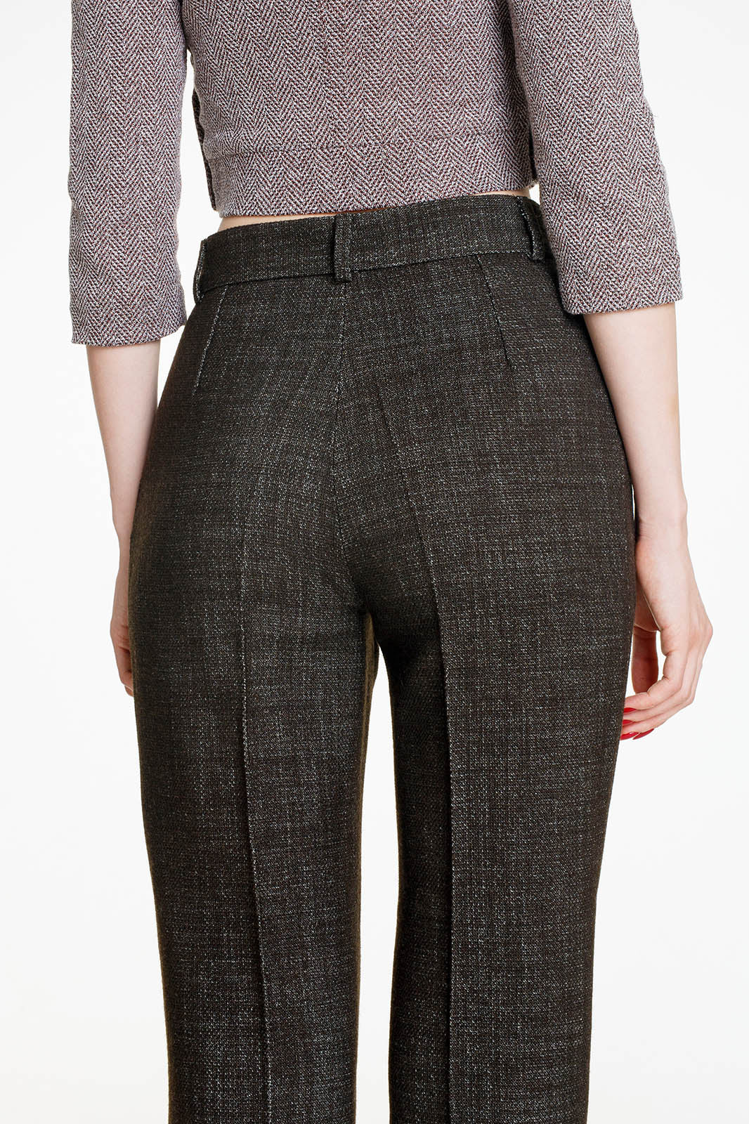 A rear view of the high-waisted olive trousers. The image shows the precise fit across the hips and the vertical darts that provide structure, leading into the straight-leg silhouette.