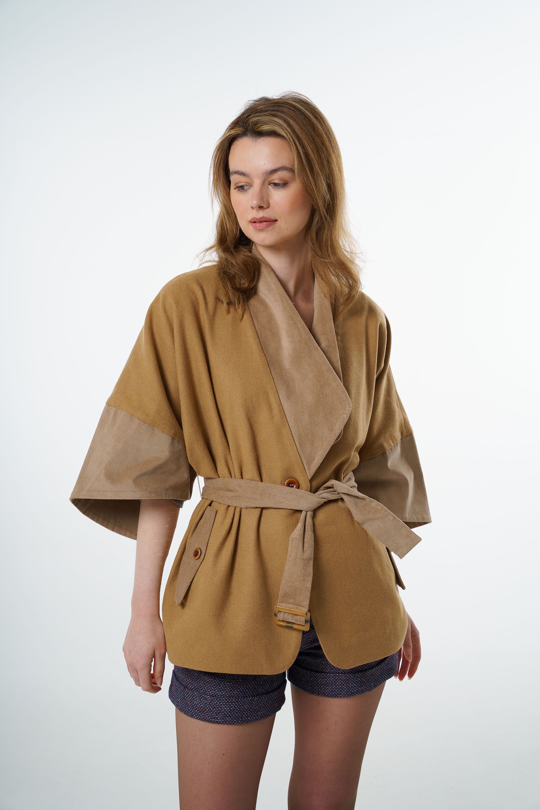 Front view of a tan-beige wool-cotton blend belted jacket with beige corduroy collar and wide kimono sleeves.