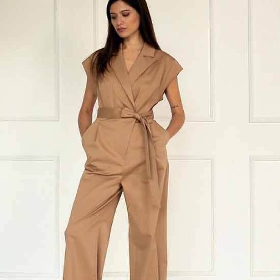 A studio video showing the camel wrap‑front wide‑leg jumpsuit in a cotton–viscose blend, highlighting the drape, tied waist, and relaxed wide‑leg silhouette.